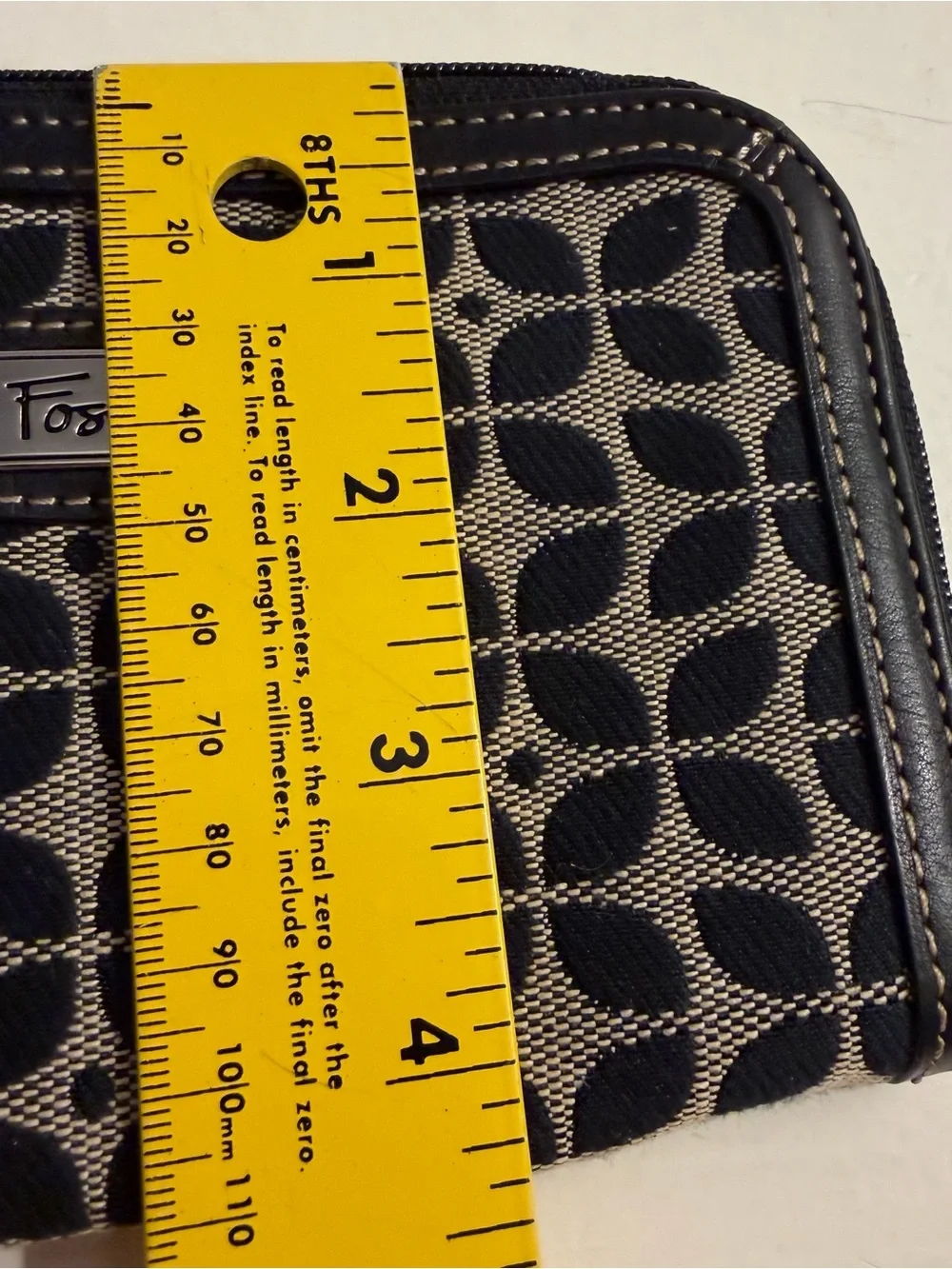 Fossil monogram canvas wristlet/wallet with leather trim.